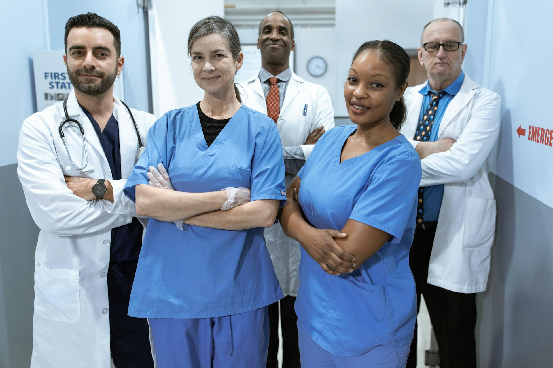 group of doctors standing together, looking at the camera and smiling