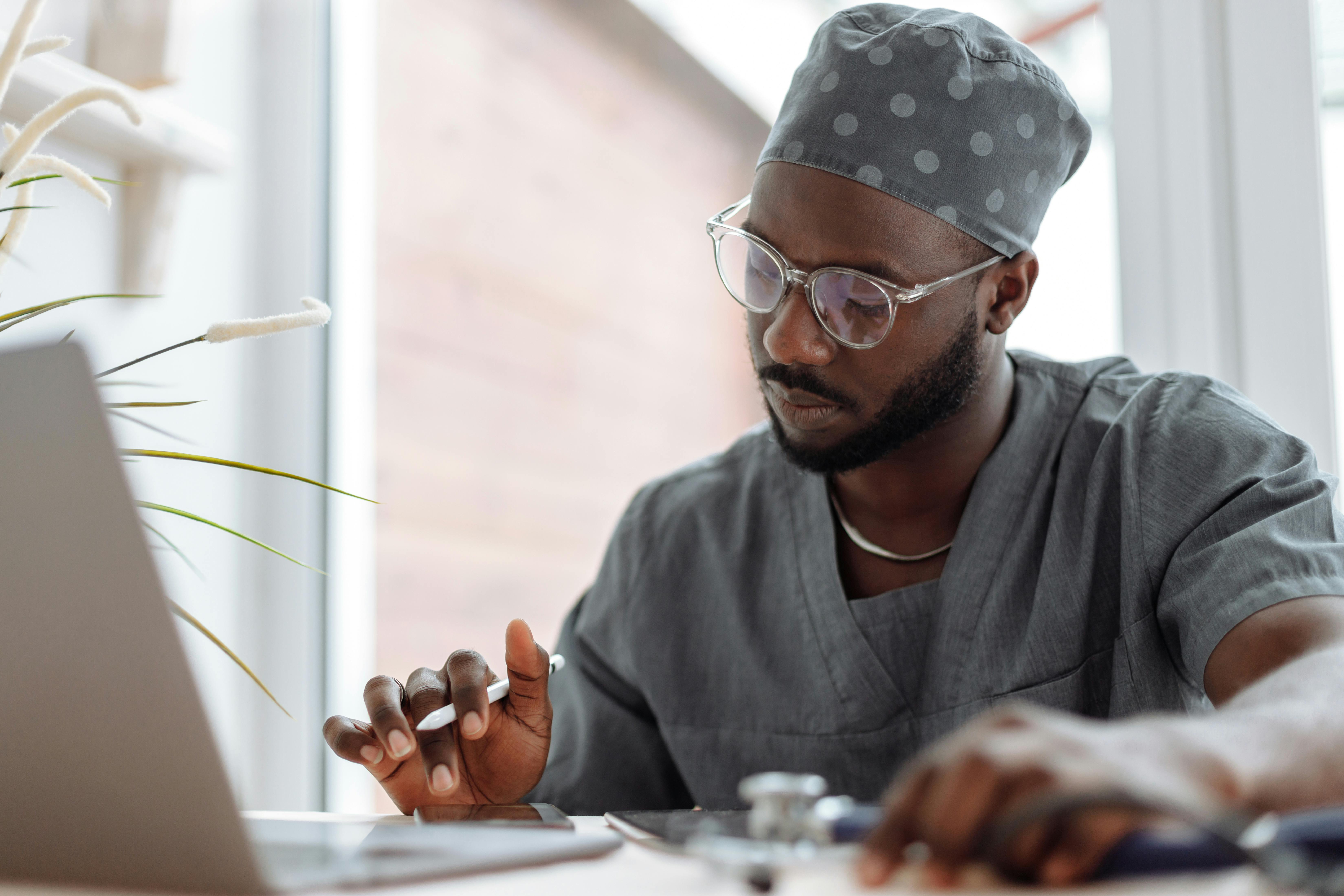 a photo of a doctor working on their laptop
